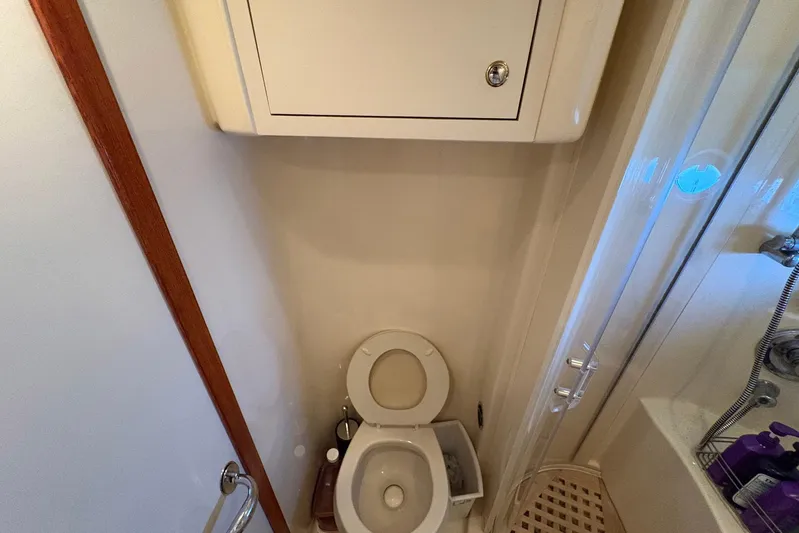 Andiamo II Yacht Photos Pics Bathroom interior of 2002 Sea Ray 480 Motor Yacht, featuring toilet and shower area.