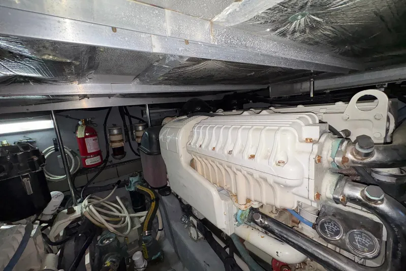 Andiamo II Yacht Photos Pics Engine room of 2002 Sea Ray 480 Motor Yacht with visible machinery and fire extinguisher.