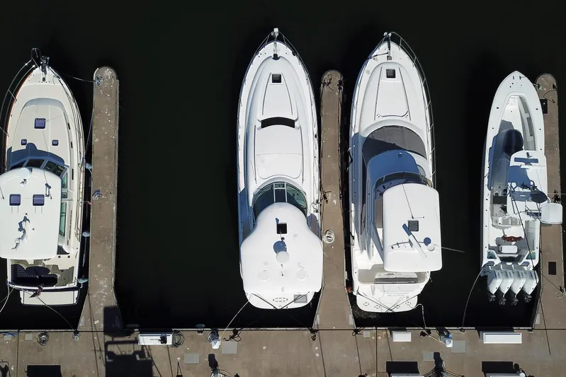 Andiamo II Yacht Photos Pics Aerial view of four yachts docked, featuring a 2002 Sea Ray 480 Motor Yacht.