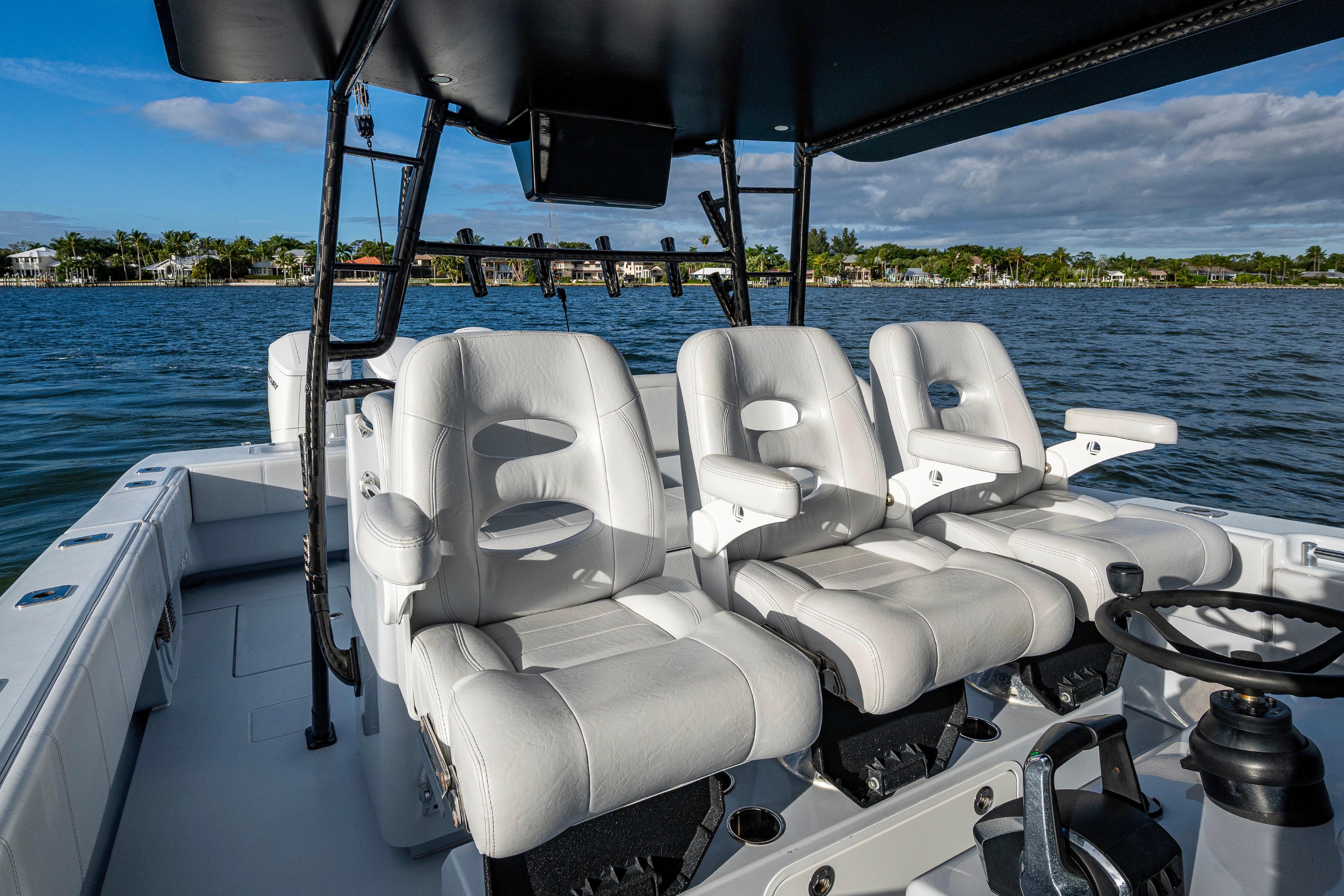 2024 Contender 44 ST boat interior with luxurious white seating and ocean backdrop.