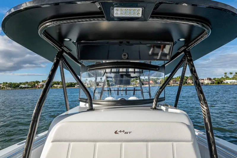  Yacht Photos Pics 2024 Contender 44 ST boat on water, showcasing sleek design and modern features.