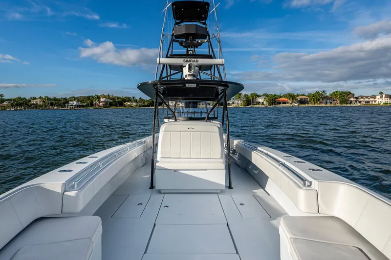  Yacht Photos Pics 2024 Contender 44 ST boat on water, showcasing spacious deck and sleek design.