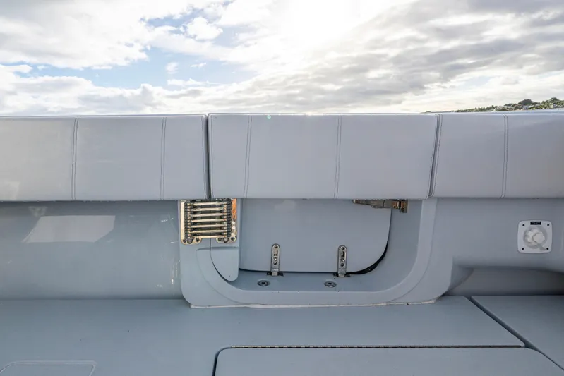  Yacht Photos Pics Rear view of 2024 Contender 44 ST boat deck under cloudy sky.