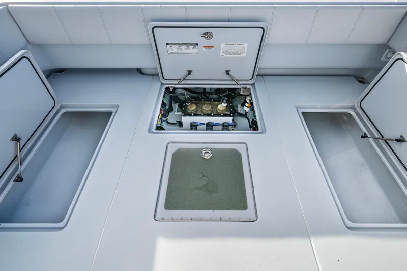  Yacht Photos Pics 2024 Contender 44 ST boat deck with open storage compartments and engine access.