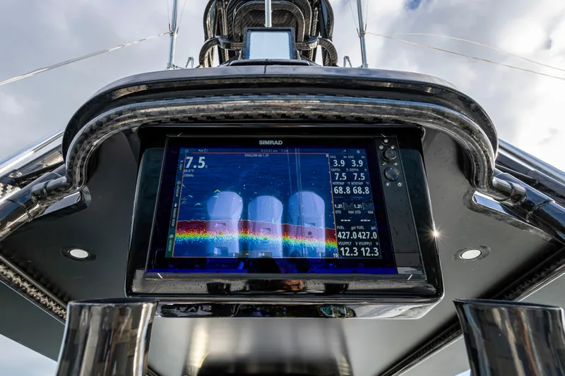  Yacht Photos Pics 2024 Contender 44 ST boat dashboard with Simrad display showing navigation data.