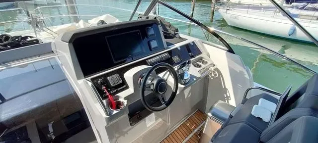  Yacht Photos Pics 2019 Jeanneau Cap Camarat 10.5 WA helm with modern controls and navigation screens.