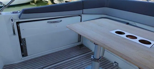  Yacht Photos Pics 2019 Jeanneau Cap Camarat 10.5 WA interior with wooden table and seating.