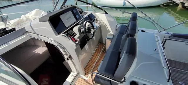  Yacht Photos Pics 2019 Jeanneau Cap Camarat 10.5 WA boat interior with steering console and seating.