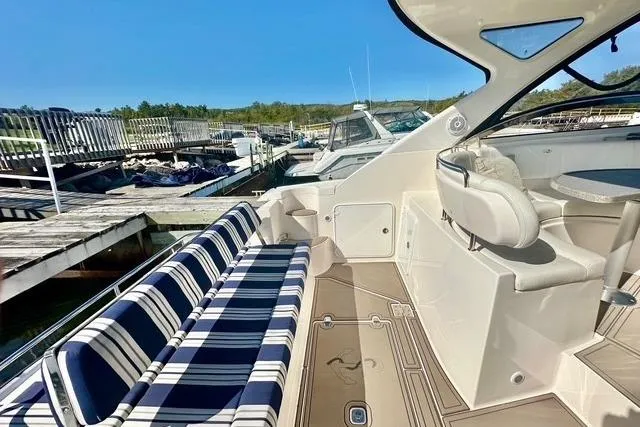  Yacht Photos Pics 2006 Regal Commodore 3560 yacht with striped seating at a marina dock.
