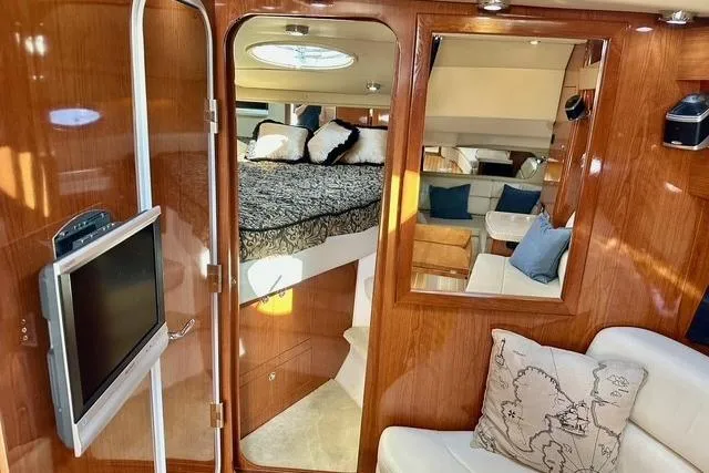  Yacht Photos Pics Luxurious interior of 2006 Regal Commodore 3560 yacht with cozy bedroom and modern amenities.