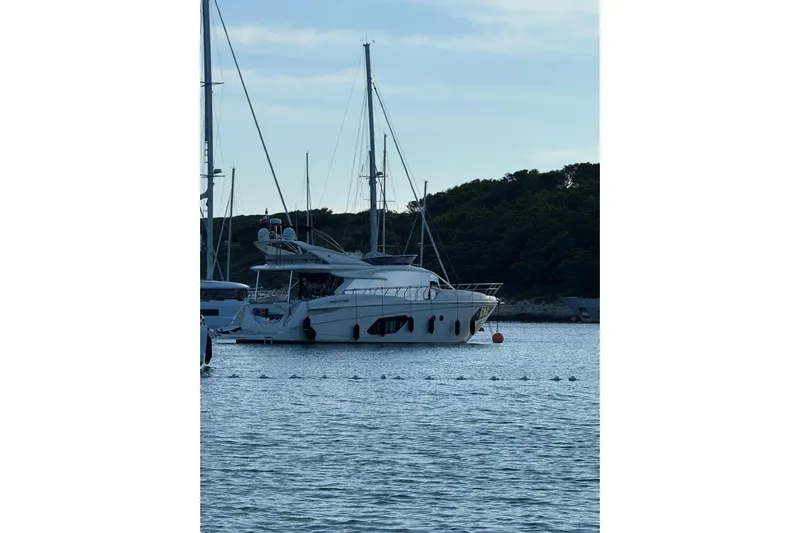  Yacht Photos Pics Luxury yacht Absolute 52 FLY 2018 docked in serene marina setting.