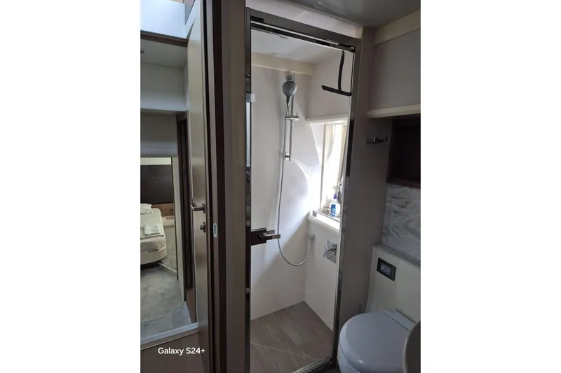  Yacht Photos Pics Bathroom interior of 2018 Absolute 52 FLY yacht, featuring shower and modern amenities.