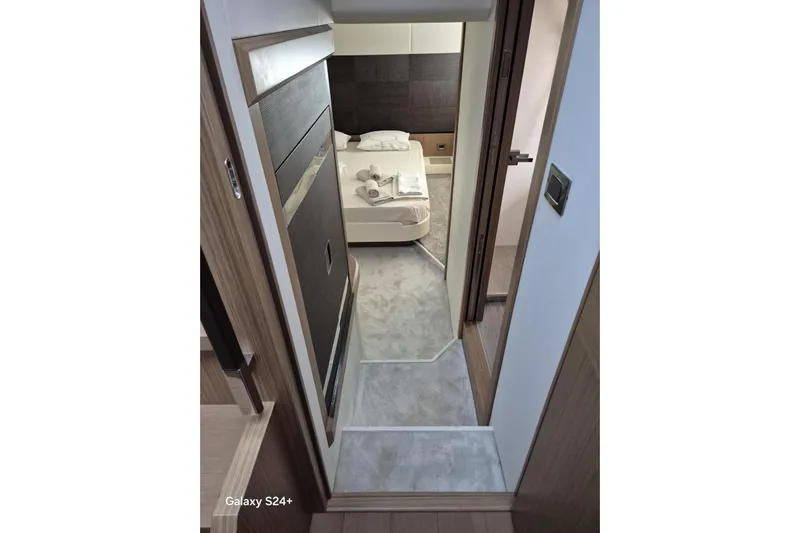  Yacht Photos Pics Luxurious interior of 2018 Absolute 52 FLY yacht, featuring a cozy bedroom.