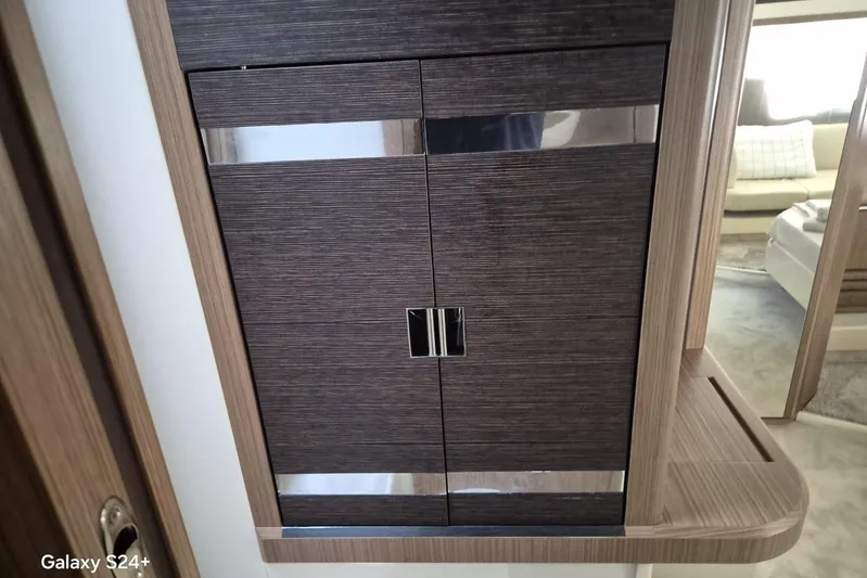  Yacht Photos Pics Interior of 2018 Absolute 52 FLY yacht, featuring sleek wooden cabinetry design.