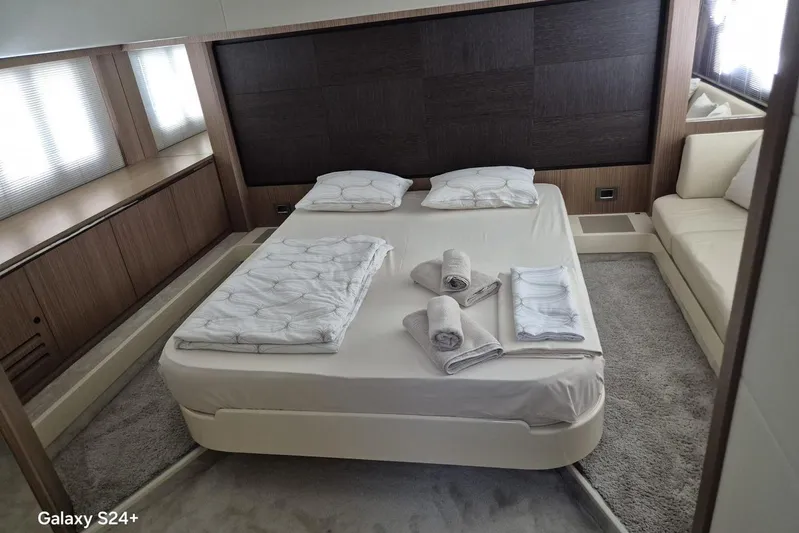  Yacht Photos Pics Luxurious bedroom interior of 2018 Absolute 52 FLY yacht with neatly arranged bedding.