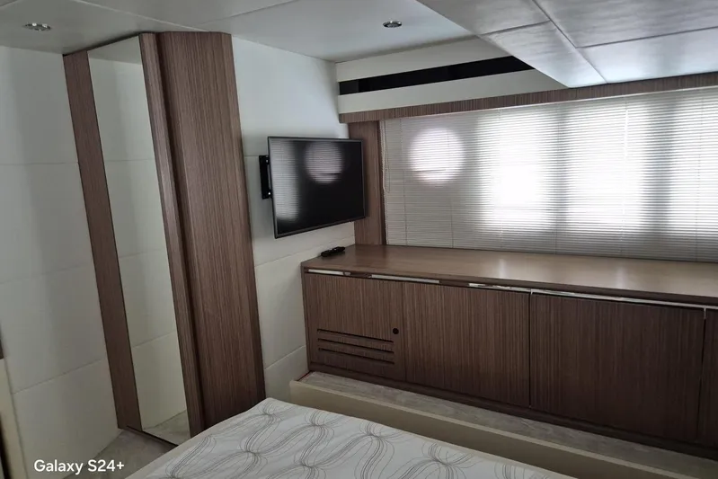  Yacht Photos Pics Luxurious interior of 2018 Absolute 52 FLY yacht with modern wood finishes and TV.