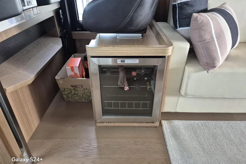  Yacht Photos Pics Interior of 2018 Absolute 52 FLY yacht with mini fridge and seating area.