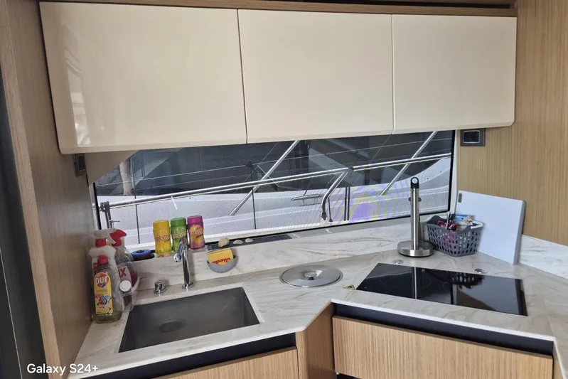  Yacht Photos Pics Modern kitchen interior on a 2018 Absolute 52 FLY yacht, featuring sleek countertops and appliances.