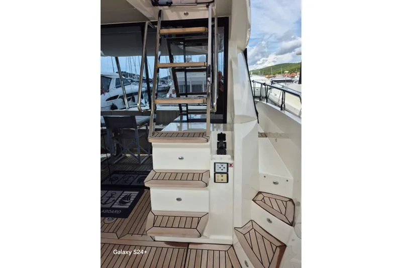  Yacht Photos Pics Staircase on 2018 Absolute 52 FLY yacht with teak decking and marina view.