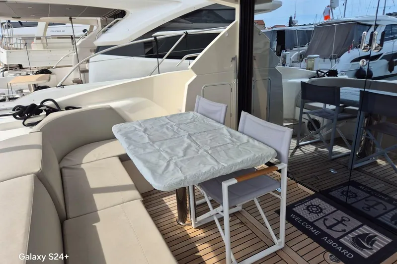  Yacht Photos Pics Outdoor seating area on 2018 Absolute 52 FLY yacht with table and chairs.