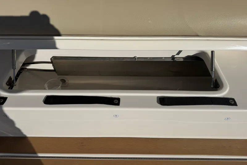  Yacht Photos Pics Storage compartment on a 2022 Tiara Yachts 43 Open boat, featuring hydraulic supports.