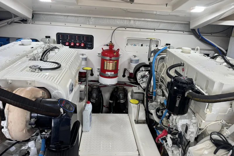  Yacht Photos Pics Engine room of 2022 Tiara Yachts 43 Open, featuring dual engines and fire extinguisher.