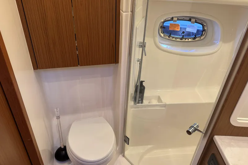  Yacht Photos Pics Bathroom interior of 2022 Tiara Yachts 43 Open, featuring shower and toilet.