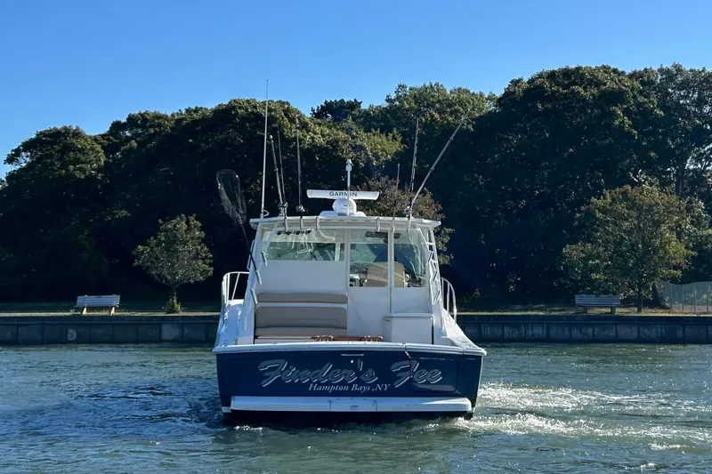  Yacht Photos Pics 2022 Tiara Yachts 43 Open boat on water, Hampton Bays, NY, surrounded by trees.