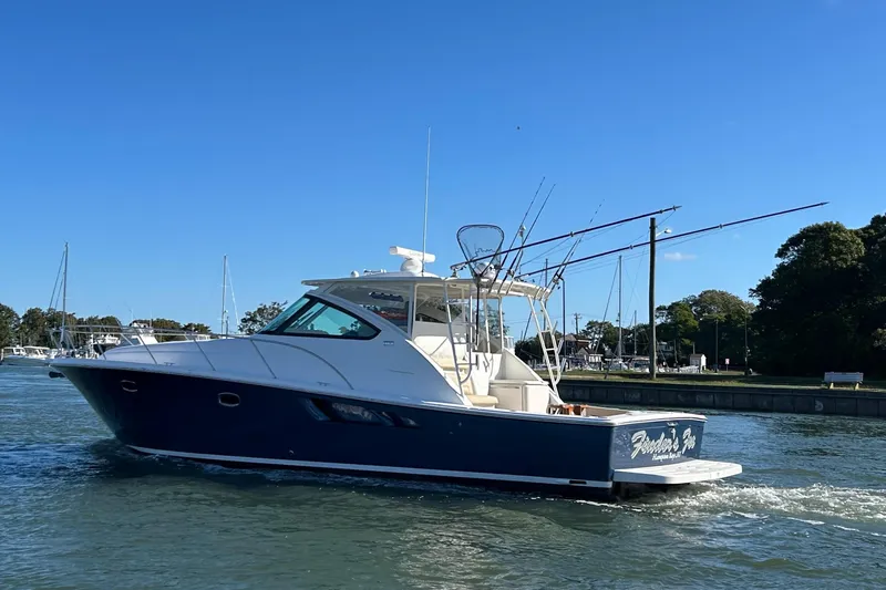  Yacht Photos Pics 2022 Tiara Yachts 43 Open cruising on a sunny day near a marina.