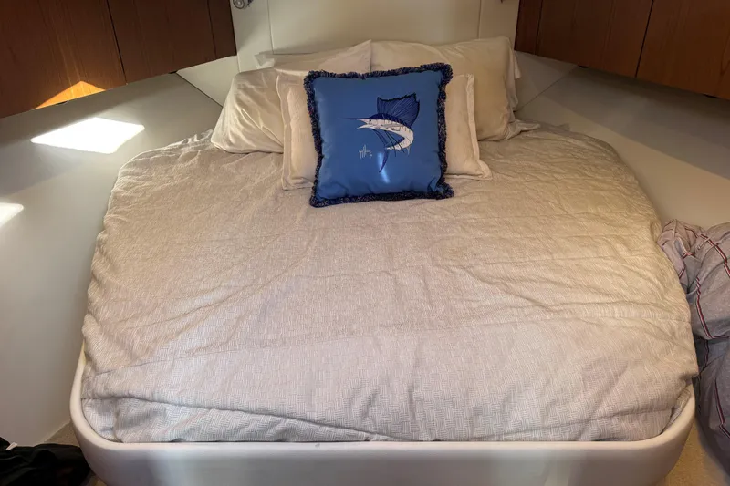  Yacht Photos Pics Cozy bedroom in 2022 Tiara Yachts 43 Open with nautical-themed decor.