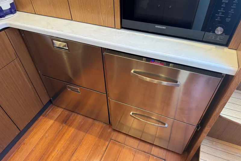  Yacht Photos Pics Modern kitchen area in 2022 Tiara Yachts 43 Open, featuring stainless steel appliances.