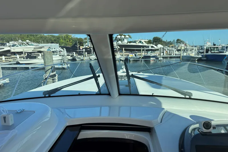  Yacht Photos Pics Interior view from 2022 Tiara Yachts 43 Open, overlooking marina with multiple boats.