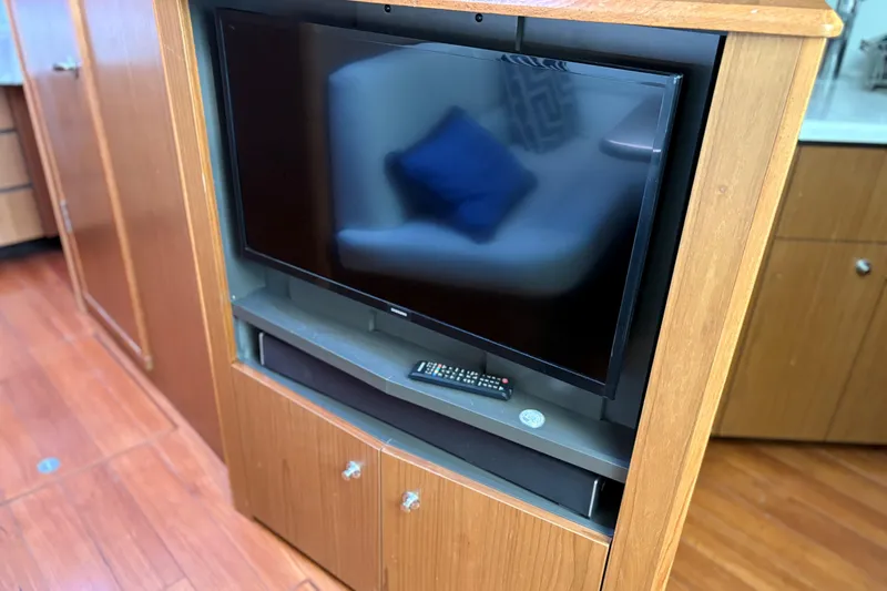  Yacht Photos Pics Entertainment center with TV and remote on Tiara Yachts 43 Open, 2022 model.