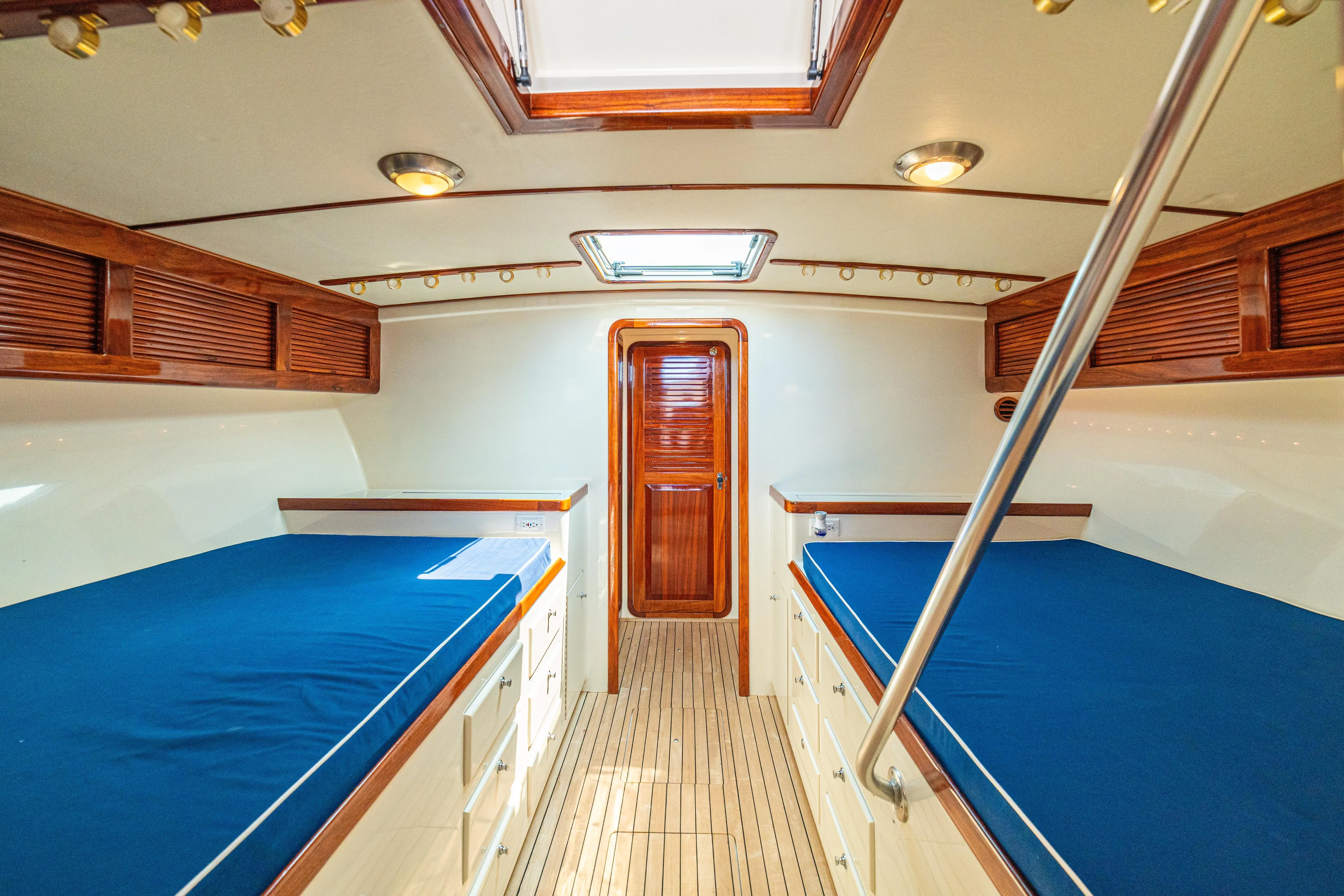 Pez Collector Yacht Photos Pics 2010 Custom Marcam 43 Convertible cabin with twin beds and wooden accents.