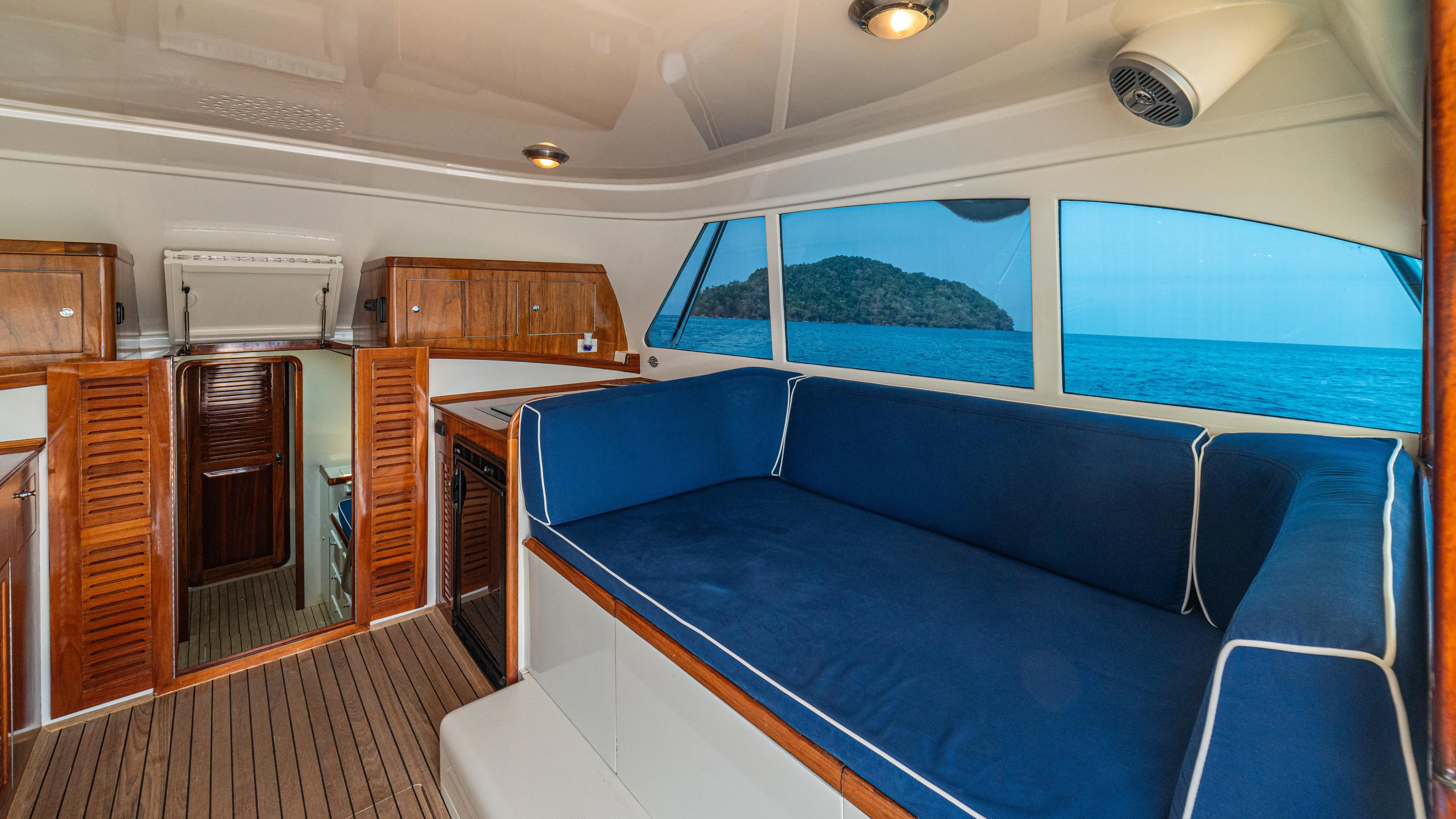 Pez Collector Yacht Photos Pics Interior of 2010 Custom Marcam 43 Convertible yacht with blue seating and ocean view.