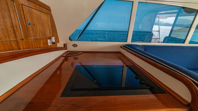 Pez Collector Yacht Photos Pics Interior of 2010 Custom Marcam 43 Convertible yacht with wooden cabinetry and ocean view.