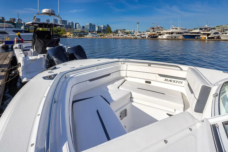  Yacht Photos Pics 2021 Blackfin 252DC boat docked in a marina with cityscape background.