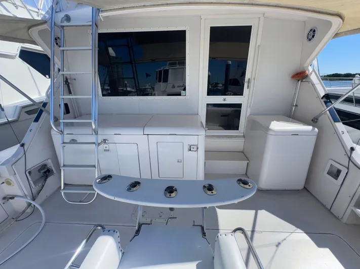 Hear After Yacht Photos Pics 1995 Bertram 50 Convertible yacht deck with ladder and seating area.