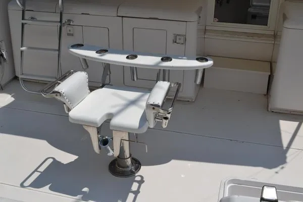 Hear After Yacht Photos Pics Fishing chair on 1995 Bertram 50 Convertible yacht deck with rod holders.