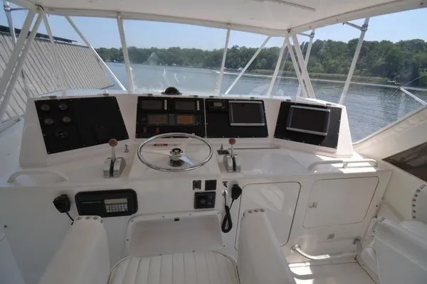 Hear After Yacht Photos Pics Helm of 1995 Bertram 50 Convertible yacht with navigation equipment and scenic water view.