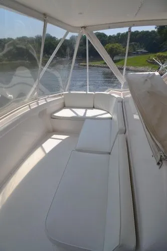 Hear After Yacht Photos Pics 1995 Bertram 50 Convertible yacht interior with white seating and scenic water view.