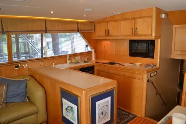 Hear After Yacht Photos Pics Interior of a 1995 Bertram 50 Convertible yacht with modern kitchen amenities.
