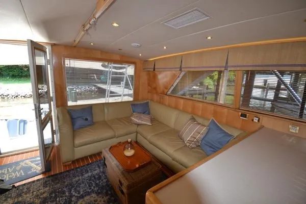 Hear After Yacht Photos Pics Luxurious interior of a 1995 Bertram 50 Convertible yacht with cozy seating.