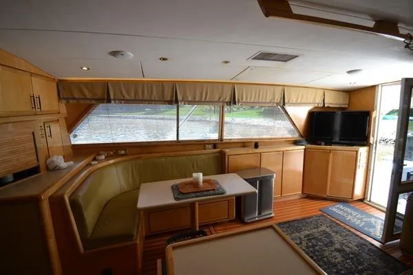 Hear After Yacht Photos Pics Interior of a 1995 Bertram 50 Convertible yacht with cozy seating and modern amenities.