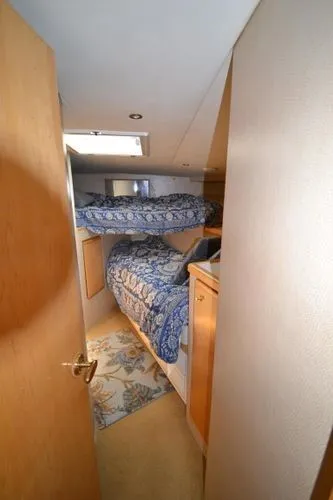 Hear After Yacht Photos Pics Interior cabin of a 1995 Bertram 50 Convertible yacht with bunk beds.
