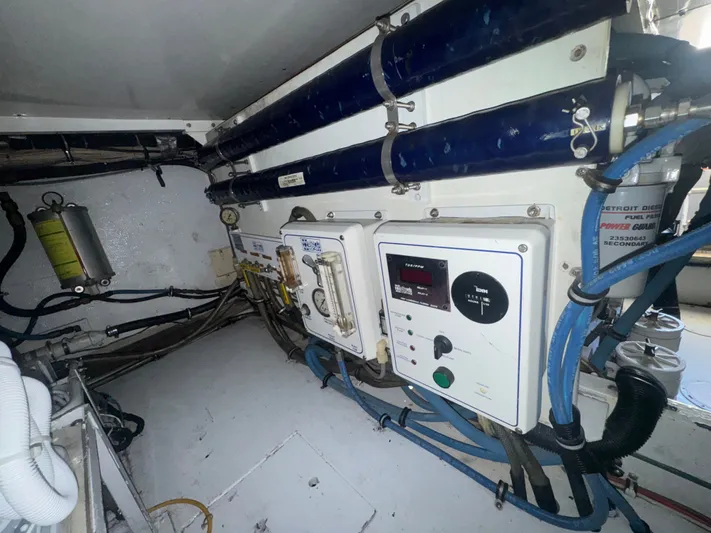 Hear After Yacht Photos Pics Engine room of a 1995 Bertram 50 Convertible with control panels and wiring.