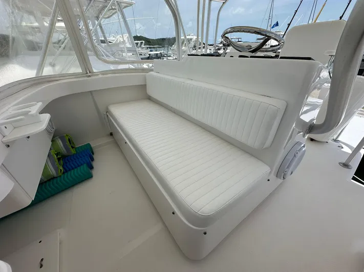  Yacht Photos Pics 2005 Luhrs 38 Convertible boat interior with white cushioned seating and helm.