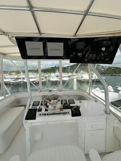  Yacht Photos Pics 2005 Luhrs 38 Convertible helm with Garmin displays and marina view.