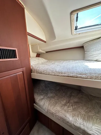  Yacht Photos Pics 2005 Luhrs 38 Convertible cabin with bunk beds and wooden cabinetry.