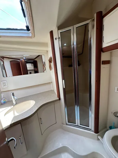  Yacht Photos Pics 2005 Luhrs 38 Convertible yacht bathroom with shower, sink, and mirror.